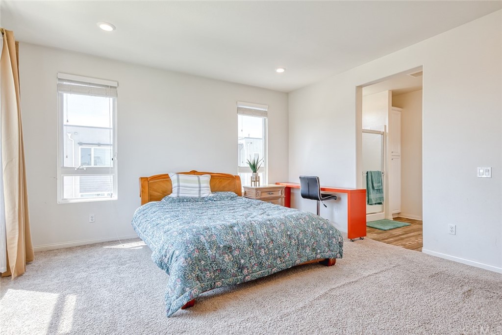 8000 Olive Lane Downey, CA 90241 - Photo 25 of 39 a bedroom with a bed and wooden floor