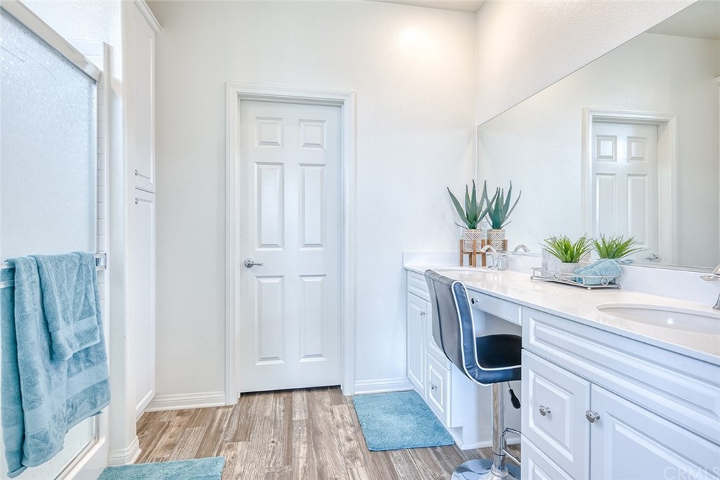 8000 Olive Lane Downey, CA 90241 - Photo 27 of 39 a view of a hallway with wooden floor and a potted plant
