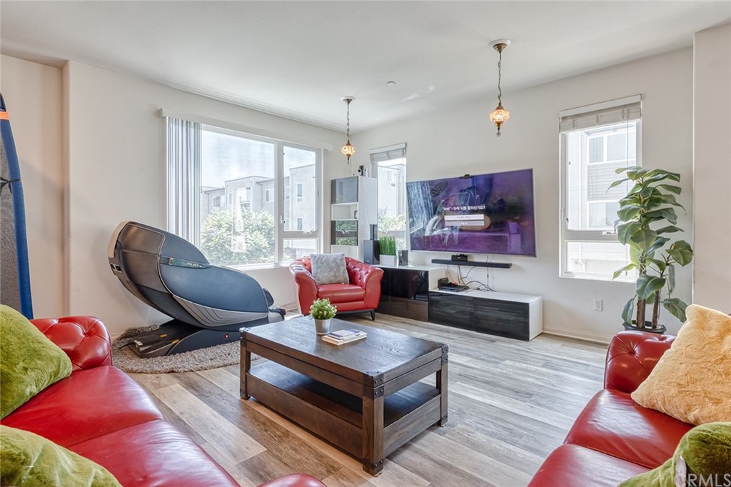 8000 Olive Lane Downey, CA 90241 - Photo 9 of 39 a living room with furniture and a flat screen tv