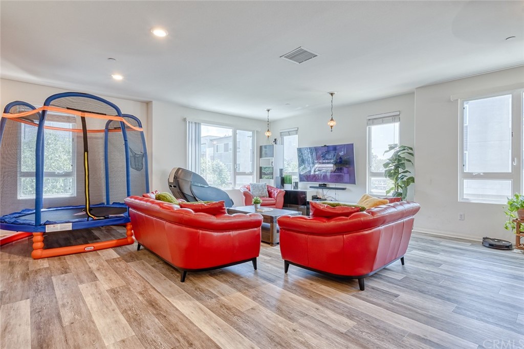 8000 Olive Lane Downey, CA 90241 - Photo 10 of 39 a living room with furniture a rug potted plant and a large window