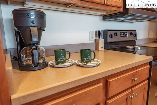 a view of kitchen island with stove and microwave