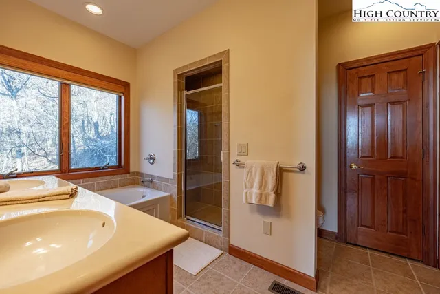 a spacious bathroom with a tub and shower