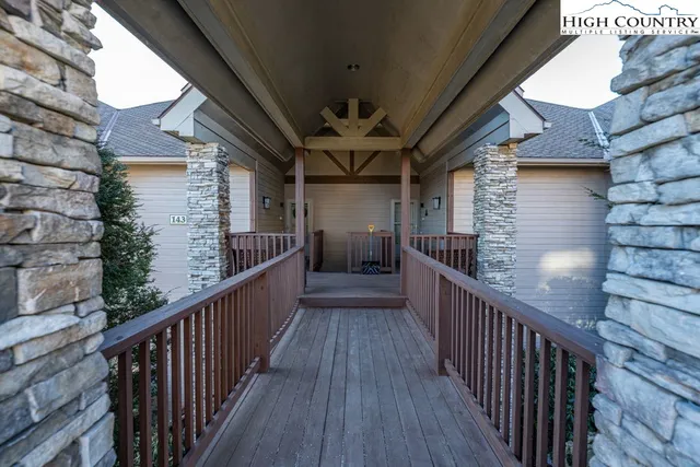 a view of a porch with wooden floor and stairs