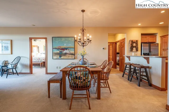 a dining room with furniture a chandelier and window