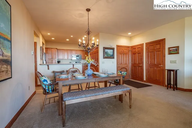 a living room with furniture a window and a chandelier