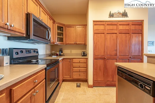 a kitchen with stainless steel appliances granite countertop a refrigerator and cabinets