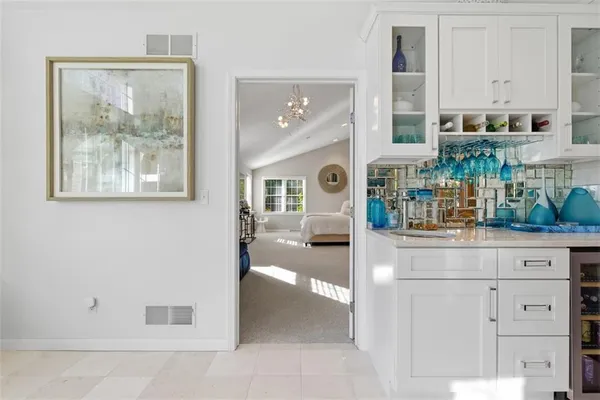 a spacious bathroom with a tub sink and mirror