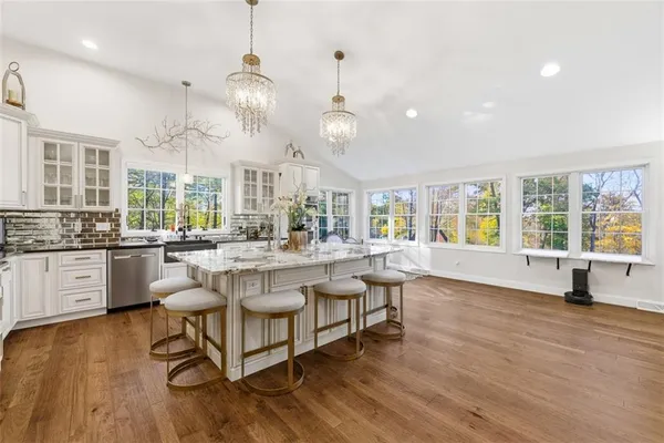 a dining room with furniture and wooden floor