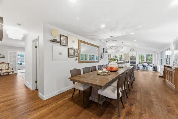 a view of a big house with a big yard and large trees