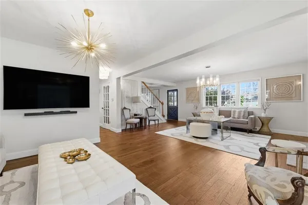a bedroom with furniture and a large window