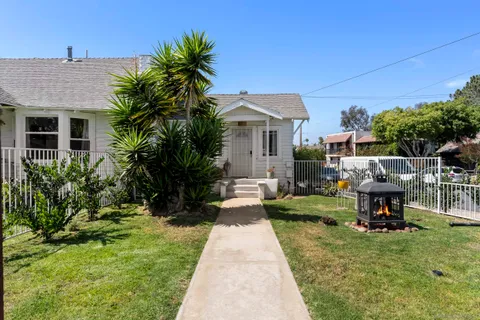 a view of a back yard with flower plants