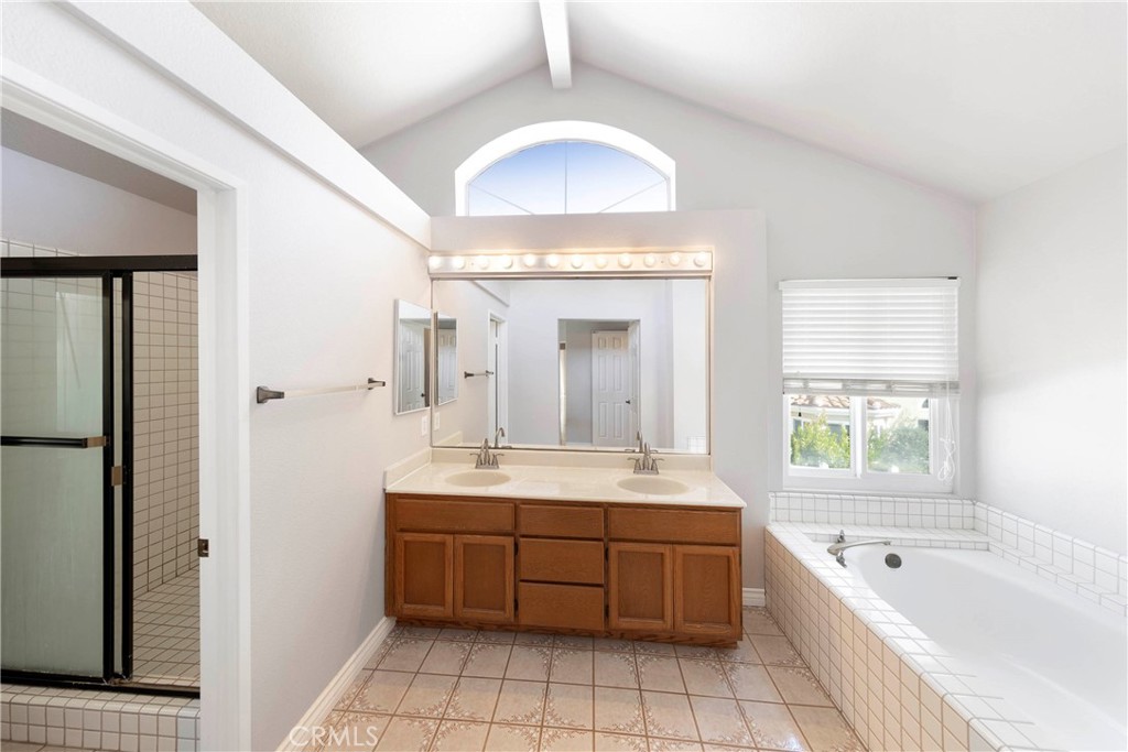 2 Bernini Irvine, CA 92614 - Photo 16 of 30 Primary ensuite featuring His and Hers vanity, walk in shower, and separate tub.