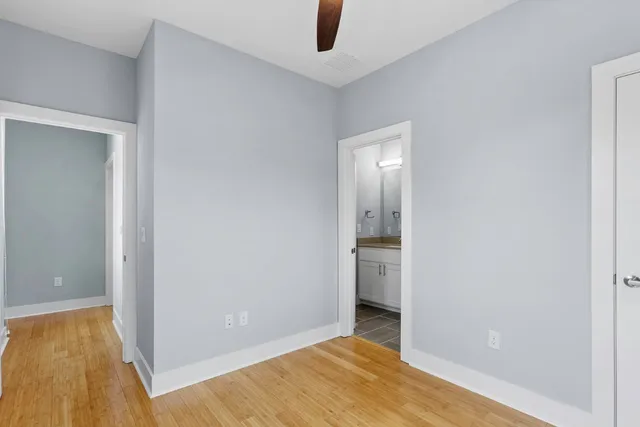 an empty room with wooden floor and entrance