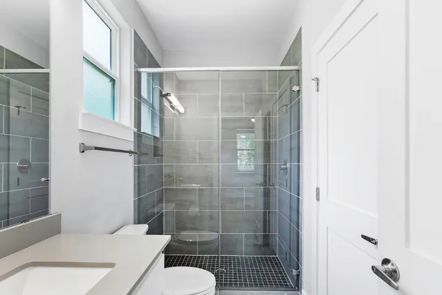 a bathroom with a shower and toilet