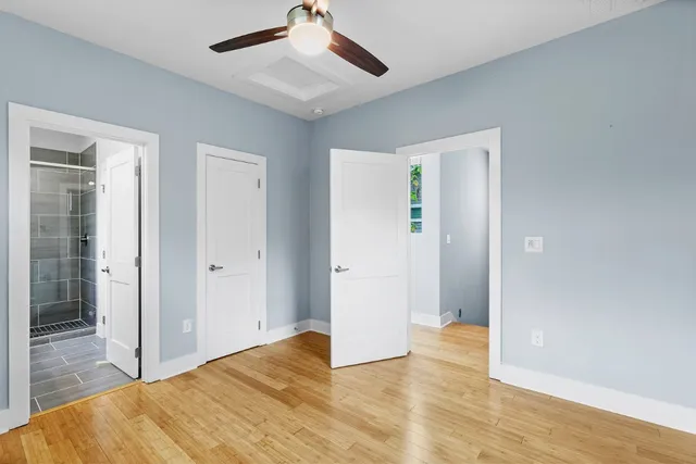a view of empty room with wooden floor