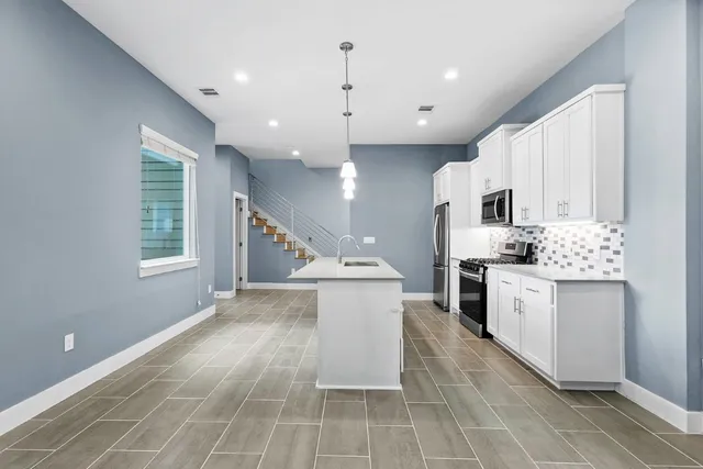 a kitchen with a sink stove and cabinets