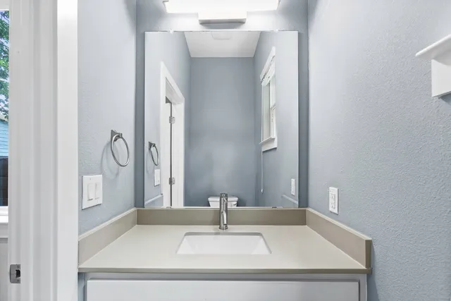 a bathroom with a sink and a mirror