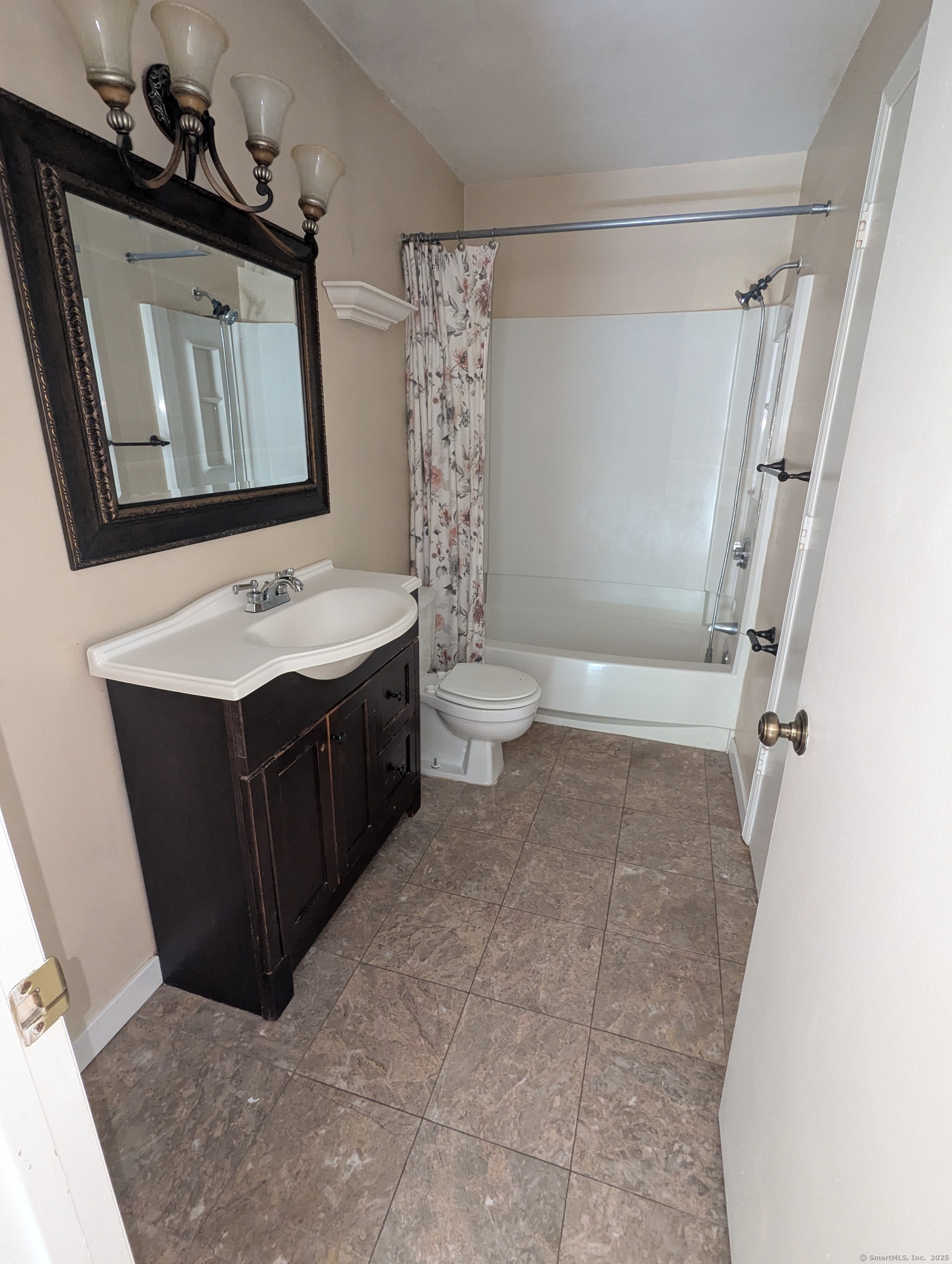 925 Oronoke Road, Unit 38F Waterbury, CT 06708 - Photo 12 of 15 a bathroom with a toilet sink and mirror