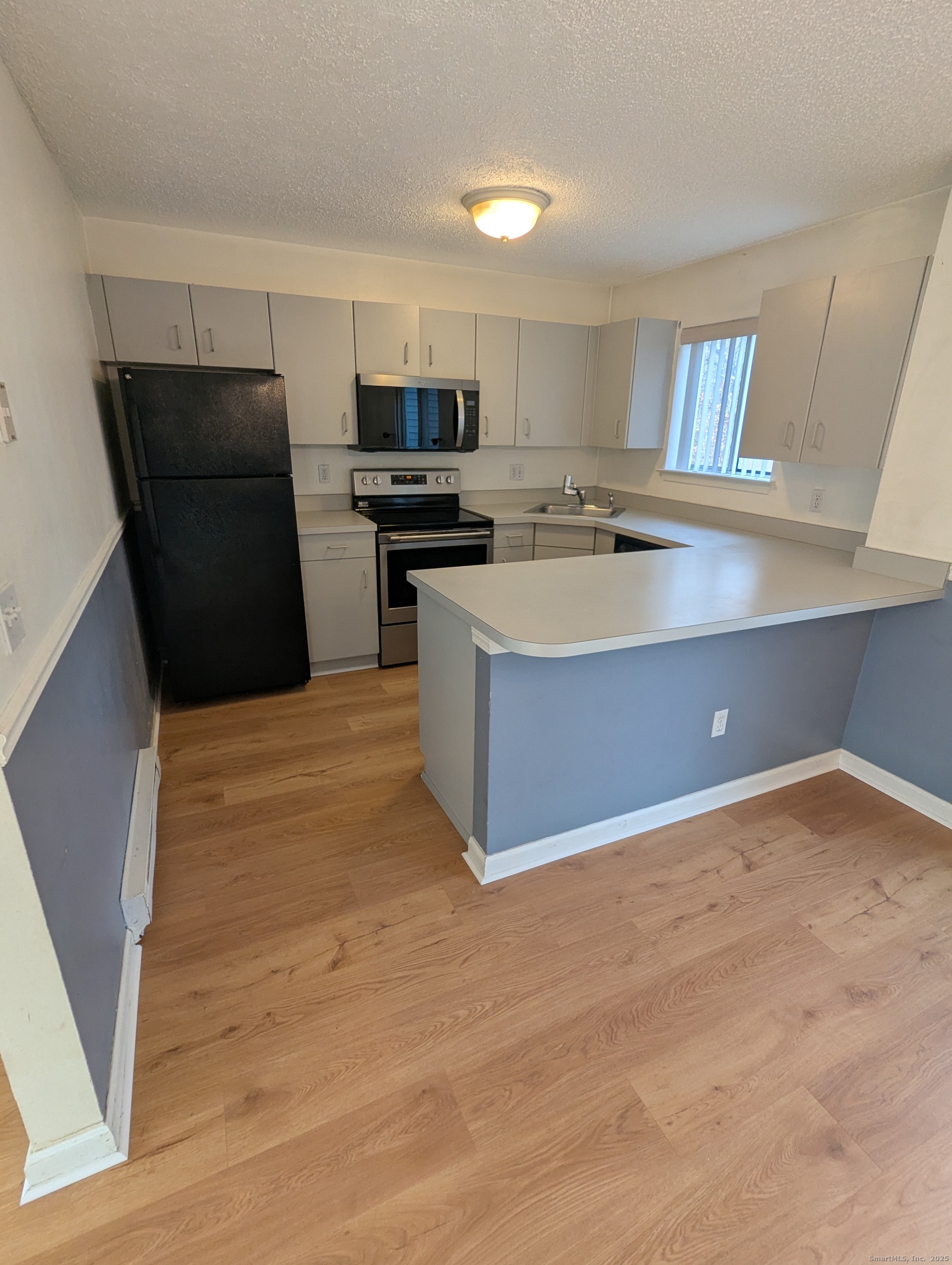 925 Oronoke Road, Unit 38F Waterbury, CT 06708 - Photo 2 of 15 a kitchen with stainless steel appliances a refrigerator sink and cabinets