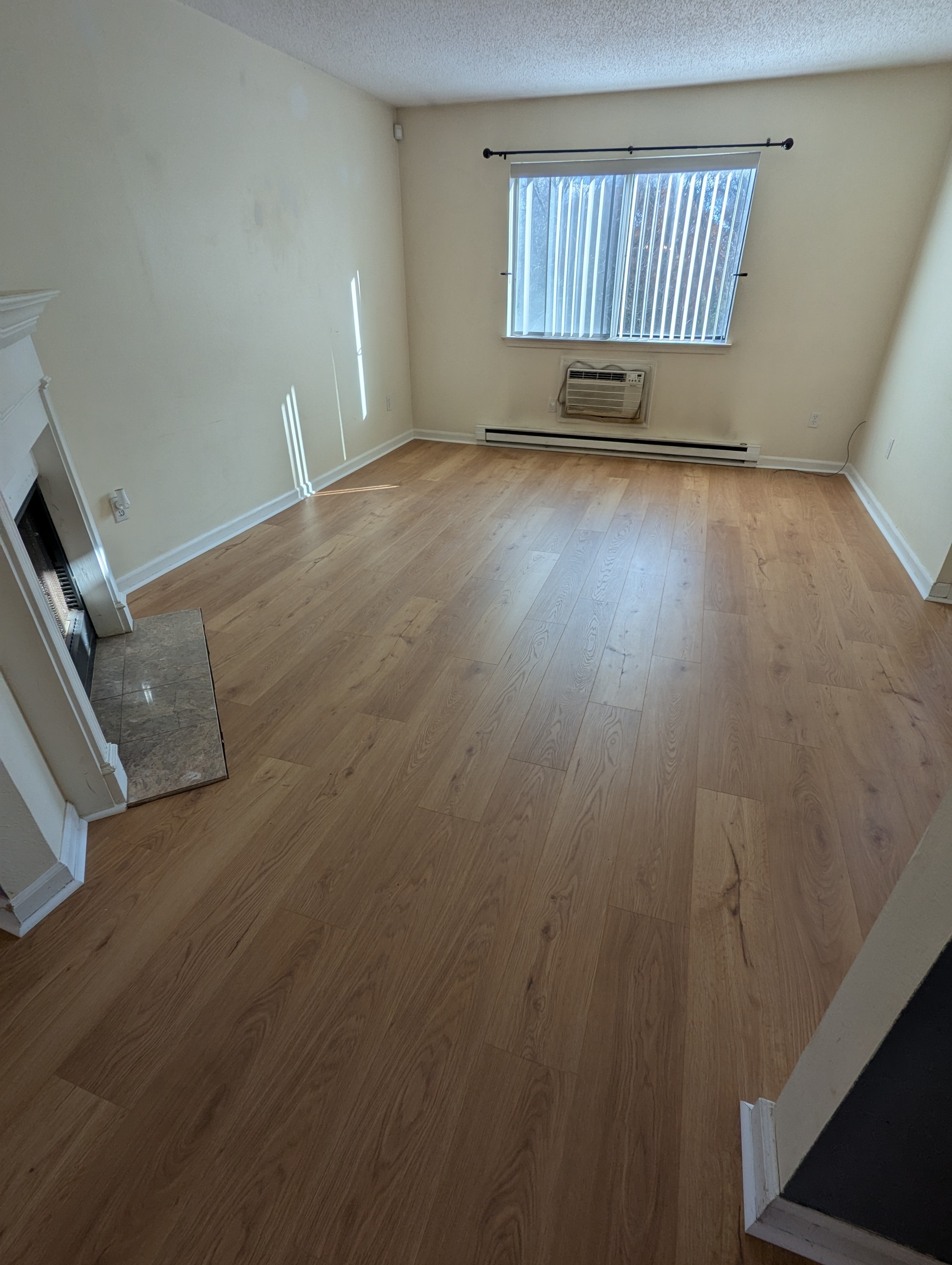 925 Oronoke Road, Unit 38F Waterbury, CT 06708 - Photo 5 of 15 an empty room with wooden floor and windows