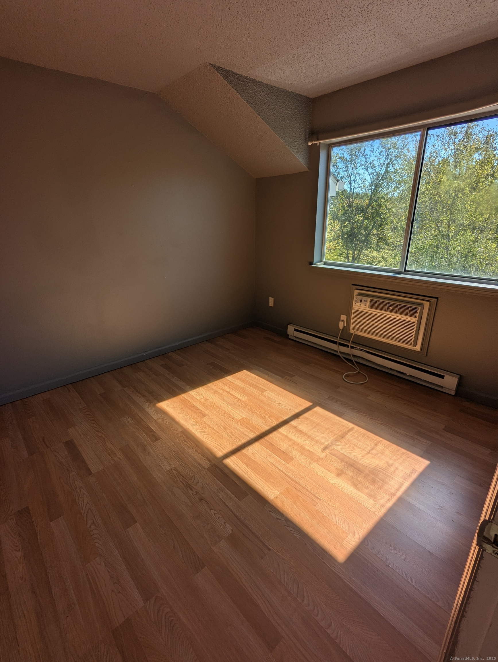 925 Oronoke Road, Unit 38F Waterbury, CT 06708 - Photo 10 of 15 an empty room with wooden floor and windows