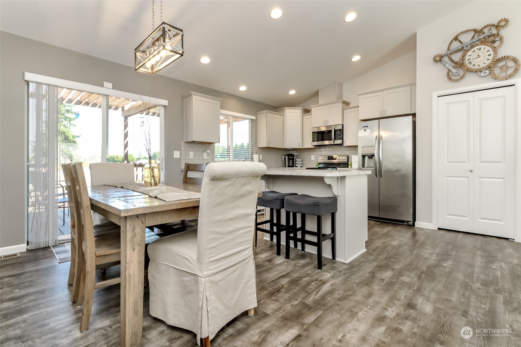 18217 Lawton Lane Southwest Rochester, WA 98579 - Photo 13 of 40 a kitchen with kitchen island a refrigerator and a dining table