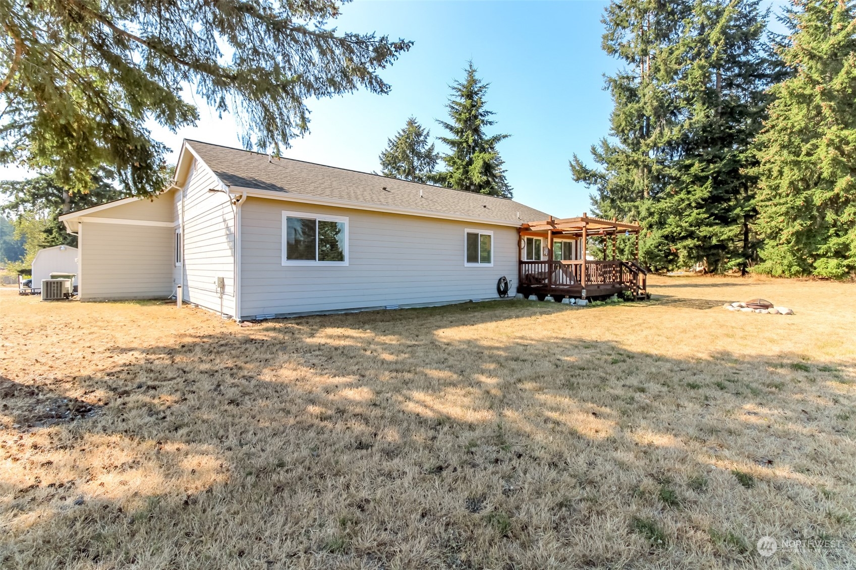 18217 Lawton Lane Southwest Rochester, WA 98579 - Photo 27 of 40 a view of house with yard and trees in the background