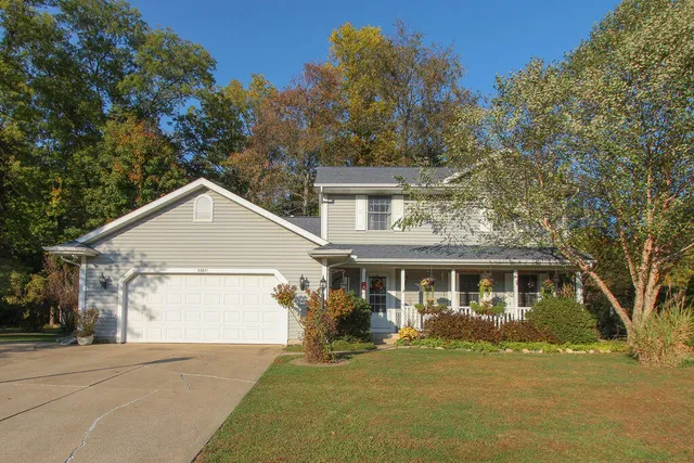 a view of a yard in front of a house with large trees