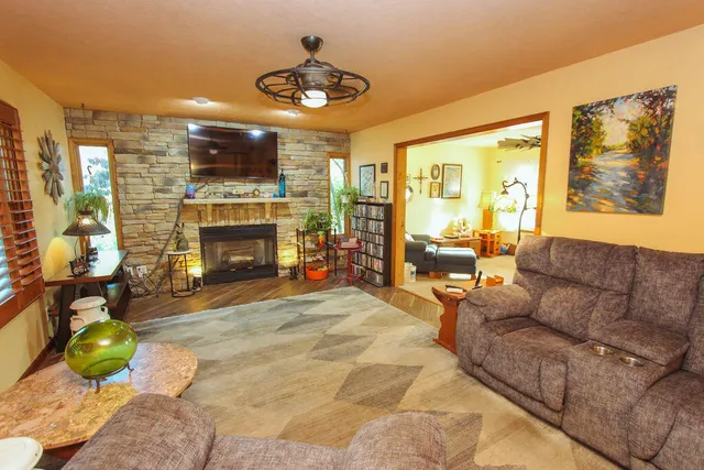 a living room with furniture a fireplace and a flat screen tv