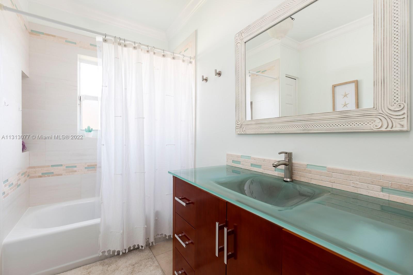 625 Southwest 27th Road Miami, FL 33129 - Photo 18 of 29 a bathroom with a sink a bathtub and a shower
