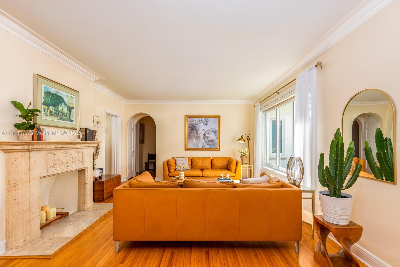 625 Southwest 27th Road Miami, FL 33129 - Photo 5 of 29 a living room with furniture a fireplace and a potted plant