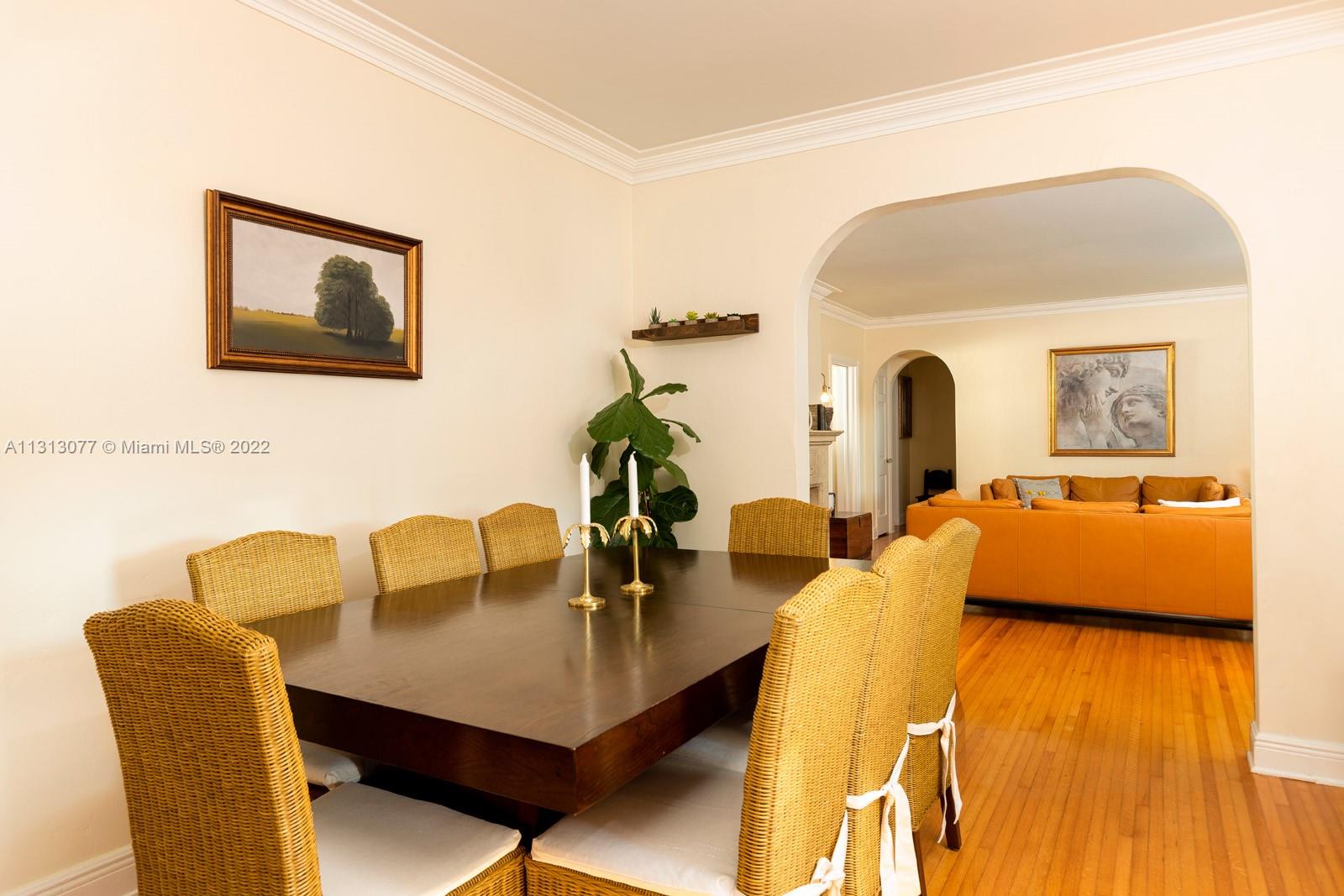625 Southwest 27th Road Miami, FL 33129 - Photo 7 of 29 a living room with dining table and paintings on the wall