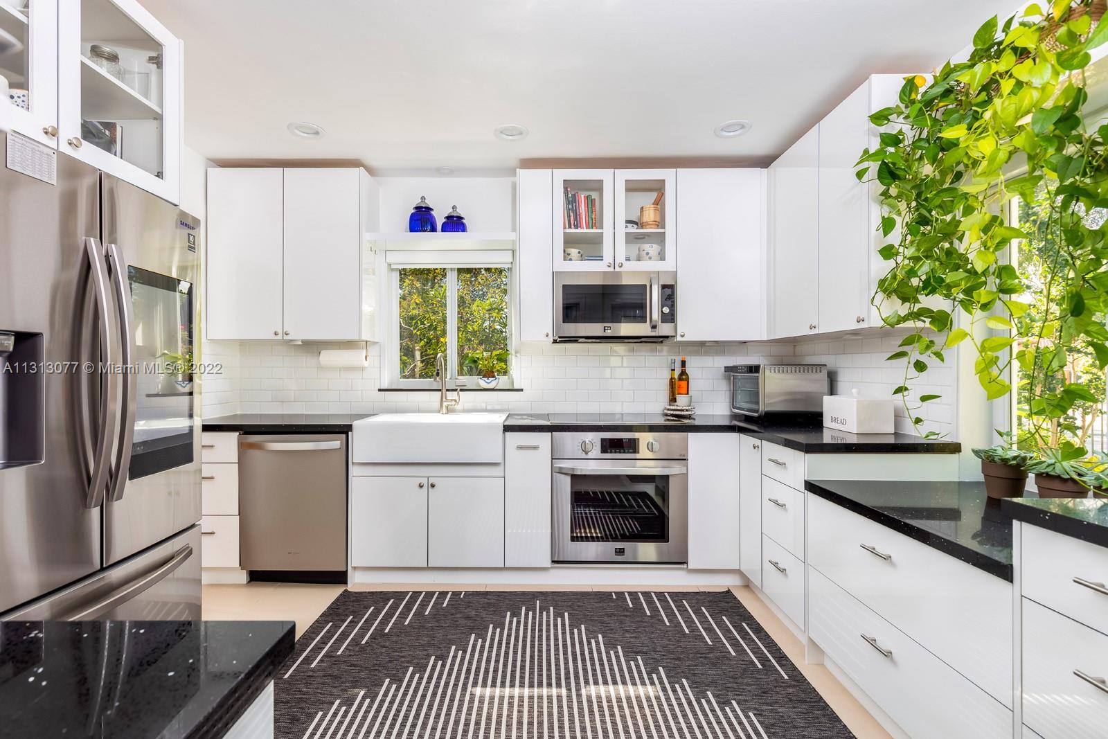 625 Southwest 27th Road Miami, FL 33129 - Photo 9 of 29 a kitchen with a refrigerator stove and sink