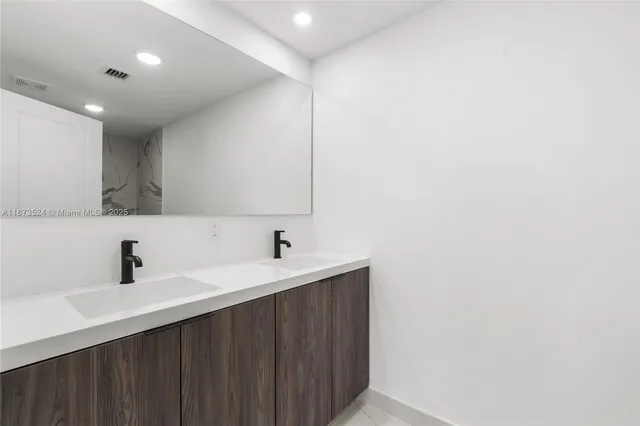 a kitchen with a sink and a mirror