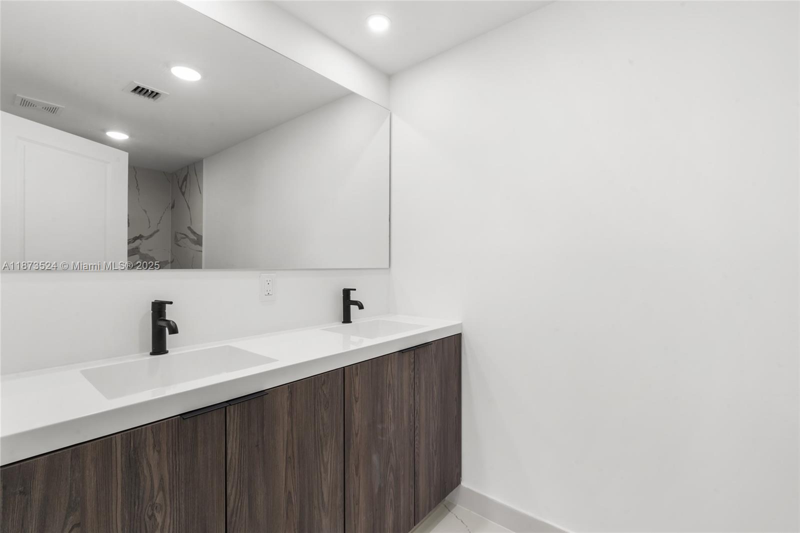 14530 Southwest 261st Terrace, Unit 2 Homestead, FL 33032 - Photo 11 of 23 a kitchen with a sink and a mirror