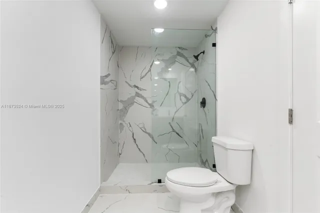 a white toilet sitting next to a shower curtain