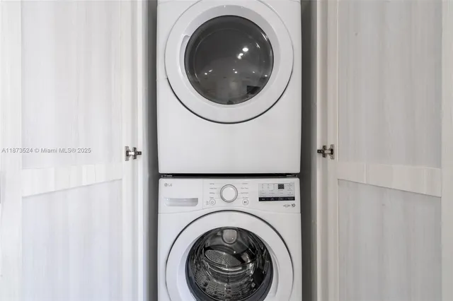 a close view of a utility room with dryer and washer