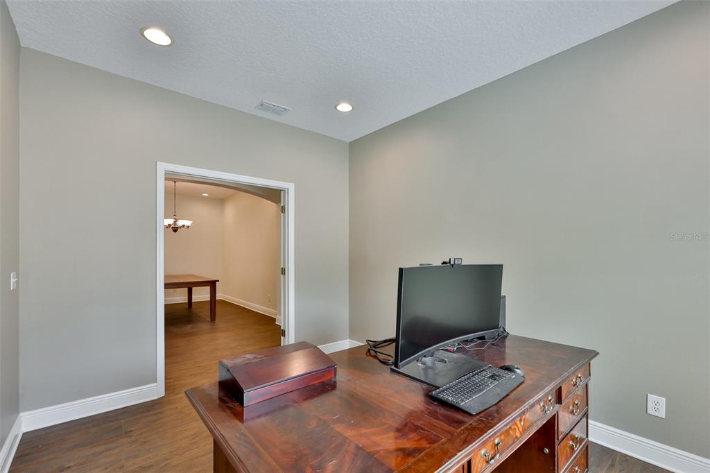708 Coade Stone Drive Seffner, FL 33584 - Photo 9 of 48 a workspace with furniture and wooden floor