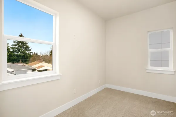 a view of a small space with wooden floor and a window