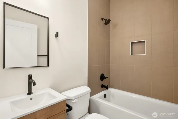 a white bath tub sitting next to a white toilet