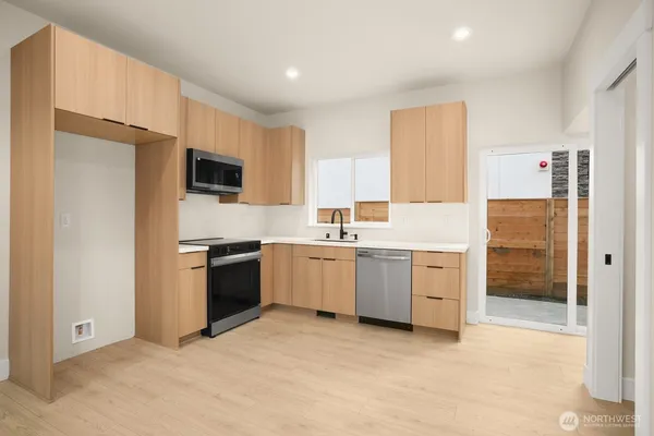 a kitchen with a sink stove and refrigerator