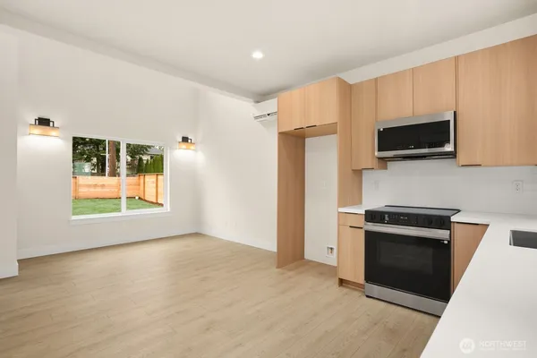 a kitchen with a stove a microwave a sink and a refrigerator