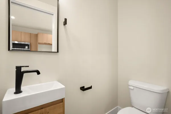 a bathroom with a sink a mirror and toilet