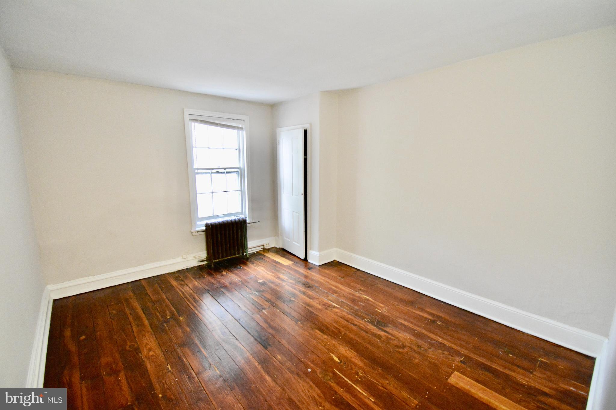 2 Penn Court Philadelphia, PA 19144 - Photo 11 of 13 a view of an empty room with wooden floor and a window