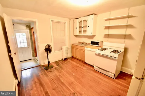 a kitchen with a stove a sink and a refrigerator