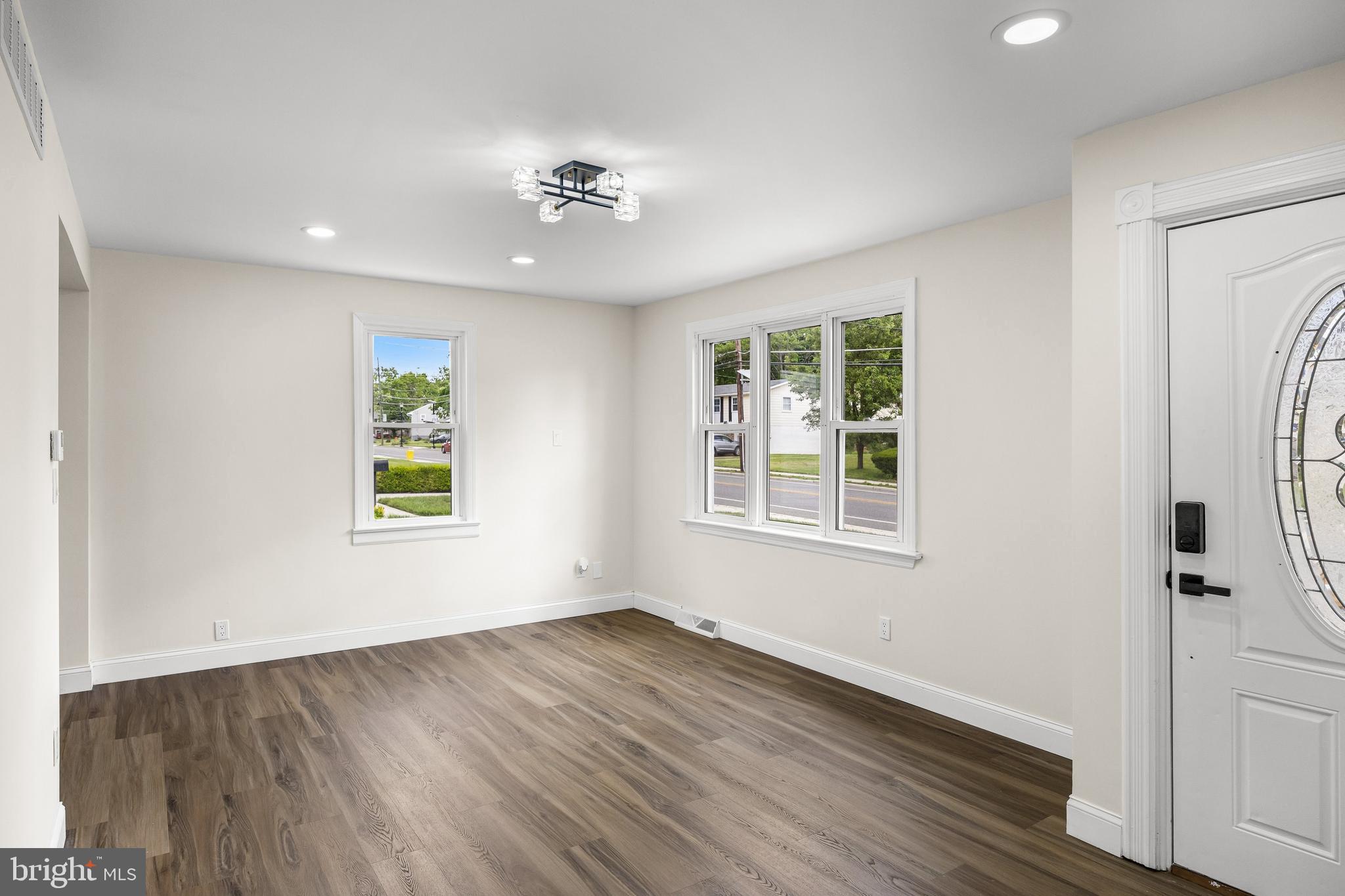 937 Clements Bridge Road Barrington, NJ 08007 - Photo 9 of 34 a view of an empty room with a window and wooden floor