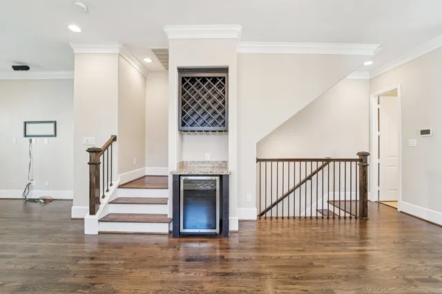 a view of a livingroom with furniture wooden floor and a ceiling fan