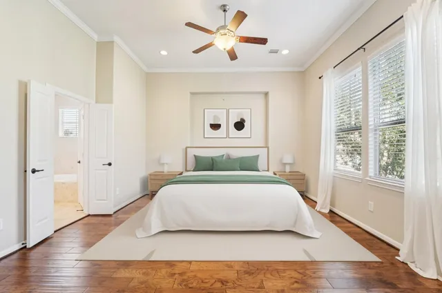 a bedroom with a large bed and a window