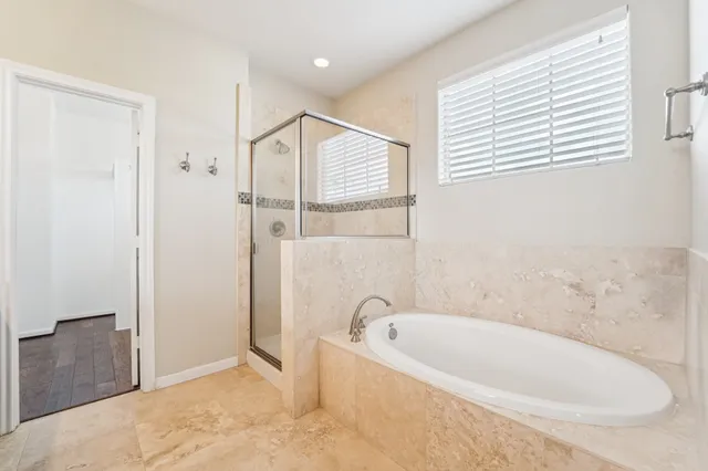 a spacious bathroom with a double vanity sink mirror and double