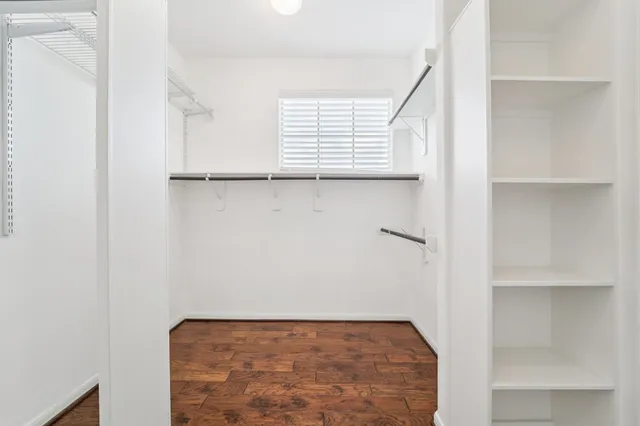 a view of a room with wooden floor